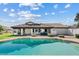 Home's backyard featuring a swimming pool, covered patio, and outdoor seating area at 10205 E Corrine Dr, Scottsdale, AZ 85260