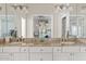 Bathroom featuring a double vanity with granite countertops, and large mirror at 10205 E Corrine Dr, Scottsdale, AZ 85260