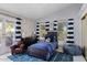 Bright bedroom features natural light, a blue accent rug, and tasteful decor at 10205 E Corrine Dr, Scottsdale, AZ 85260