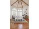 A spacious dining room features a chandelier, white shutters, wood floors, and a gray rug at 10205 E Corrine Dr, Scottsdale, AZ 85260