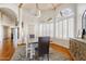 A bright dining room features wood floors, plantation shutters, and a rustic wooden sideboard at 10205 E Corrine Dr, Scottsdale, AZ 85260