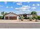 Charming single-story home featuring a tile roof, arched entry, and a three-car garage at 10205 E Corrine Dr, Scottsdale, AZ 85260