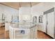 Spacious kitchen with large island, white cabinetry, and open floor plan design at 10205 E Corrine Dr, Scottsdale, AZ 85260