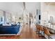 Open-concept living space with wood floors, fireplace, and seamless flow to kitchen at 10205 E Corrine Dr, Scottsdale, AZ 85260