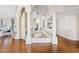 Open-concept living space with elegant columns and rich hardwood flooring at 10205 E Corrine Dr, Scottsdale, AZ 85260