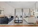 Spacious living room with hardwood floors, a fireplace, and elegant neutral-toned furniture at 10205 E Corrine Dr, Scottsdale, AZ 85260