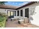 Private patio with tile flooring, comfortable seating area, and adjacent doorway to the interior of the home at 10205 E Corrine Dr, Scottsdale, AZ 85260