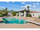 Sparkling in-ground pool featuring a diving board, cabana, and lush landscaping at 10205 E Corrine Dr, Scottsdale, AZ 85260