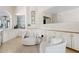 Cozy sitting area with white armchairs, custom cabinets, and stylish decor at 10205 E Corrine Dr, Scottsdale, AZ 85260