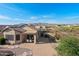 Aerial view of the home highlighting the patio, desert landscaping, and mountain views at 10607 E Hillside Mine Ct, Gold Canyon, AZ 85118