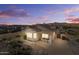 Desert backyard with dining and mountain views at dusk, showcasing outdoor living space at 10607 E Hillside Mine Ct, Gold Canyon, AZ 85118