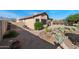 Low-maintenance backyard featuring desert landscaping with gravel, cacti, and a decorative windmill at 10607 E Hillside Mine Ct, Gold Canyon, AZ 85118