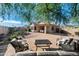 Desert landscaped backyard with dining and seating area providing a tranquil outdoor living space at 10607 E Hillside Mine Ct, Gold Canyon, AZ 85118