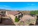 Aerial view of a backyard showcasing an outdoor dining area and desert landscaping with mountain views at 10607 E Hillside Mine Ct, Gold Canyon, AZ 85118