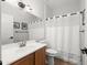 Bathroom with modern finishes, a vanity with sink, a mirror, modern lighting, toilet and shower with curtain at 10607 E Hillside Mine Ct, Gold Canyon, AZ 85118