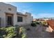 Home exterior and well-kept desert landscaping with mountain views on a bright, sunny day at 10607 E Hillside Mine Ct, Gold Canyon, AZ 85118