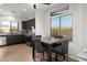 Kitchen and dining area featuring dark cabinets, stainless steel appliances, and a square table at 10607 E Hillside Mine Ct, Gold Canyon, AZ 85118