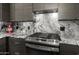 Close-up of a kitchen featuring a stainless steel stove and marble countertops at 10607 E Hillside Mine Ct, Gold Canyon, AZ 85118