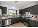 Modern kitchen with dark cabinets, granite countertops, and stainless steel appliances at 10607 E Hillside Mine Ct, Gold Canyon, AZ 85118