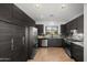 Modern kitchen featuring stainless steel appliances, dark wood cabinets, and granite countertops at 10607 E Hillside Mine Ct, Gold Canyon, AZ 85118