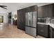 Modern kitchen featuring stainless steel appliances, dark wood cabinets, and granite countertops at 10607 E Hillside Mine Ct, Gold Canyon, AZ 85118