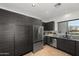 Modern kitchen featuring stainless steel appliances and dark wood cabinets at 10607 E Hillside Mine Ct, Gold Canyon, AZ 85118