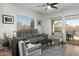 Comfortable living room with a gray sofa, chairs, and a view of the outdoor patio at 10607 E Hillside Mine Ct, Gold Canyon, AZ 85118