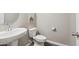 Cozy half-bath featuring modern fixtures, a pedestal sink, and tiled floors at 1281 W Highland Rd, San Tan Valley, AZ 85143