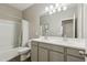 Bathroom featuring double sinks, a large mirror, wood-look tile, and a shower and tub at 1281 W Highland Rd, San Tan Valley, AZ 85143