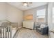 Cozy bedroom with a crib, nice rug, and neutral color scheme at 1281 W Highland Rd, San Tan Valley, AZ 85143