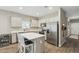 Well-lit kitchen with stainless steel appliances, an island with breakfast bar, and white cabinets at 1281 W Highland Rd, San Tan Valley, AZ 85143