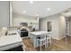 Bright kitchen featuring wood tile floors, stainless appliances, white cabinets, and a center island at 1281 W Highland Rd, San Tan Valley, AZ 85143