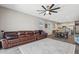 Open-concept living room with sleek ceiling fan, modern flooring, and view into the kitchen at 1281 W Highland Rd, San Tan Valley, AZ 85143