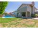 Backyard view with pool, patio, grass, and home exterior at 12813 S 38Th St, Phoenix, AZ 85044