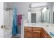 Cozy bathroom with a shower over tub, a wood vanity and a large mirror at 12813 S 38Th St, Phoenix, AZ 85044