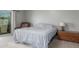 Comfortable bedroom featuring a sliding glass door, a leather chair and a wooden dresser at 12813 S 38Th St, Phoenix, AZ 85044