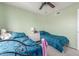 Bright bedroom featuring twin beds, ceiling fan, and minimalist white dresser at 12813 S 38Th St, Phoenix, AZ 85044