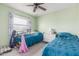 Cozy bedroom with twin beds, ceiling fan, and colorful decor at 12813 S 38Th St, Phoenix, AZ 85044