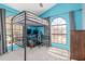 Bedroom with a loft bed, a desk and lots of natural light from an arched window at 12813 S 38Th St, Phoenix, AZ 85044