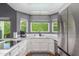 Renovated kitchen with stainless steel appliances, quartz countertops, and a bright, window-lit space at 12813 S 38Th St, Phoenix, AZ 85044