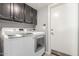 Laundry room featuring modern washer and dryer with overhead cabinets at 12813 S 38Th St, Phoenix, AZ 85044