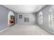 Neutral living room featuring carpet floors, arched doorways, and plantation shutters at 12813 S 38Th St, Phoenix, AZ 85044