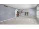 Neutral living room featuring carpet floors, arched doorways, and plantation shutters at 12813 S 38Th St, Phoenix, AZ 85044