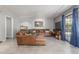 Bright living room featuring a large leather sectional, tile floors, and curtains at 12813 S 38Th St, Phoenix, AZ 85044