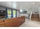 Living room features a large couch, tile floors, a staircase, and a sliding glass door to the backyard at 12813 S 38Th St, Phoenix, AZ 85044