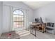 Bright office with a large arched window, two chairs, and desk at 12813 S 38Th St, Phoenix, AZ 85044