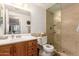 Bathroom featuring a wooden vanity and a glass-enclosed shower, blending functionality with style at 145 N 74Th St # 251, Mesa, AZ 85207