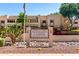 Exterior view of Sun Valley Casitas Condominiums with mature landscaping and American flag at 145 N 74Th St # 251, Mesa, AZ 85207