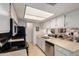 Well-lit kitchen featuring white cabinets and modern appliances for a clean and efficient cooking space at 145 N 74Th St # 251, Mesa, AZ 85207
