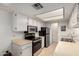 Well-lit kitchen featuring stainless steel appliances and ample counter space at 145 N 74Th St # 251, Mesa, AZ 85207